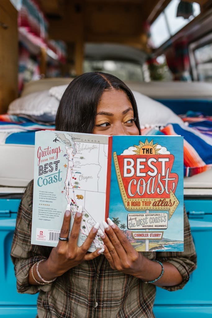 Woman Holding a Travel Guide Book and Looking to the Side